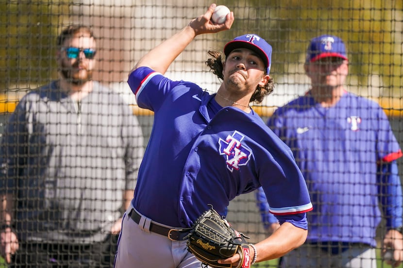 Rangers pitcher Tyler Phillips throws live batting practice during a spring training workout...