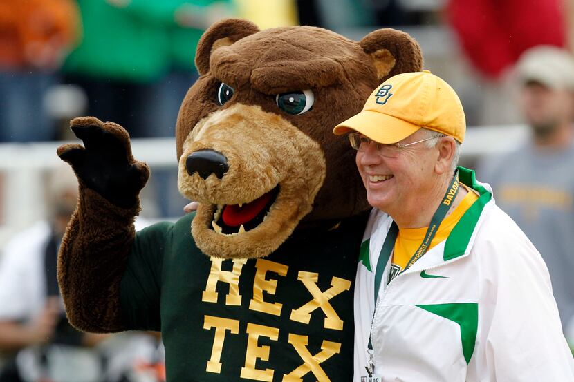Baylor University Ken Starr takes a photo with the mascot before the start of a NCAA...