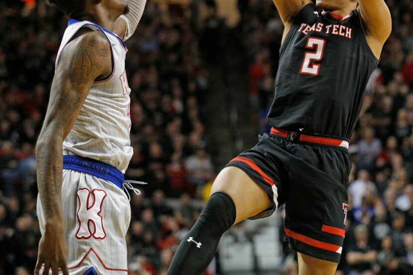 Texas Tech's Zhaire Smith (2) shoots over Kansas' Lagerald Vick (2) during the first half of...