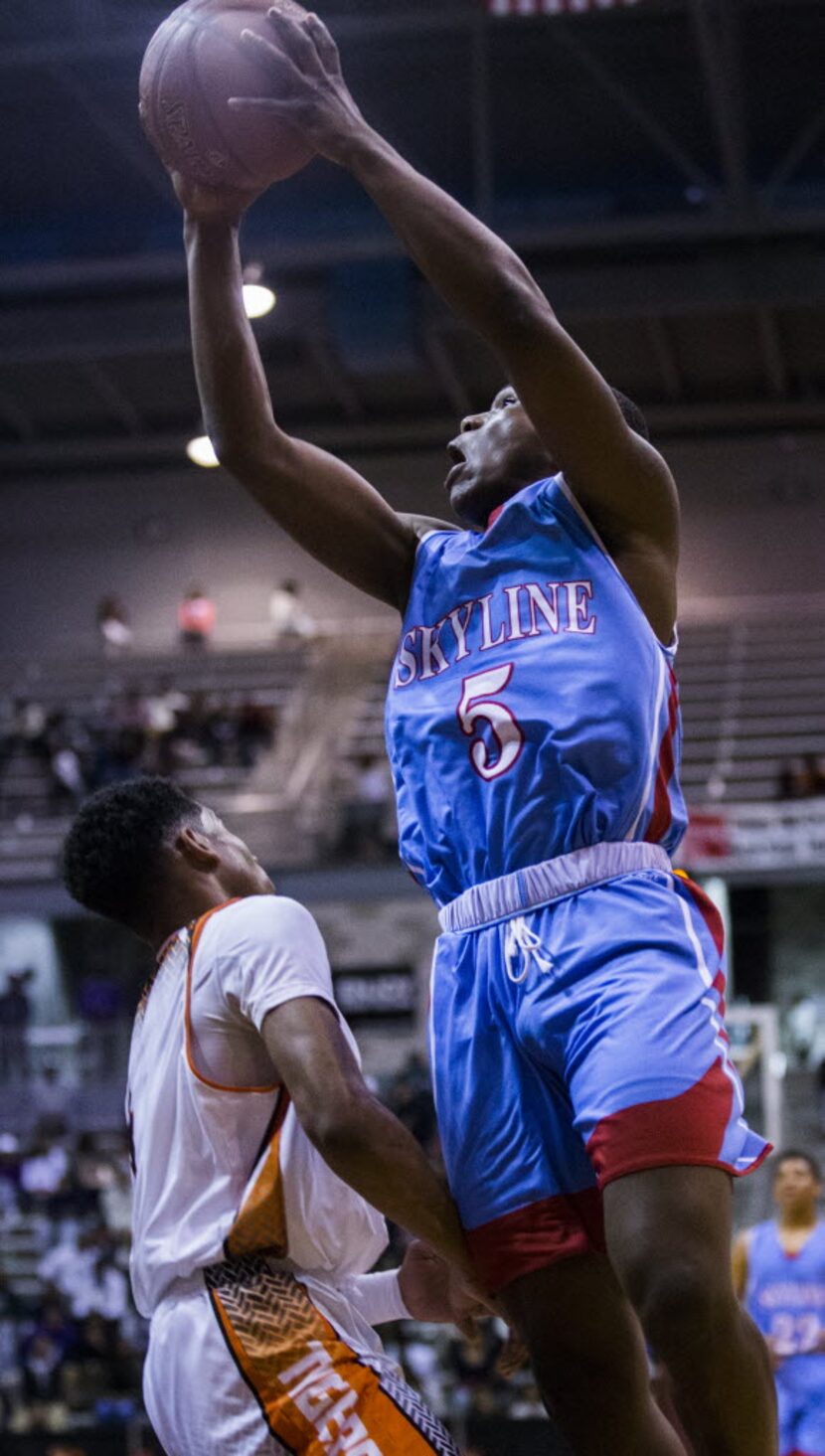 Skyline's Tivin Ridguard (5) goes up for a shot over Lancaster's Ike Durham (4) during the...