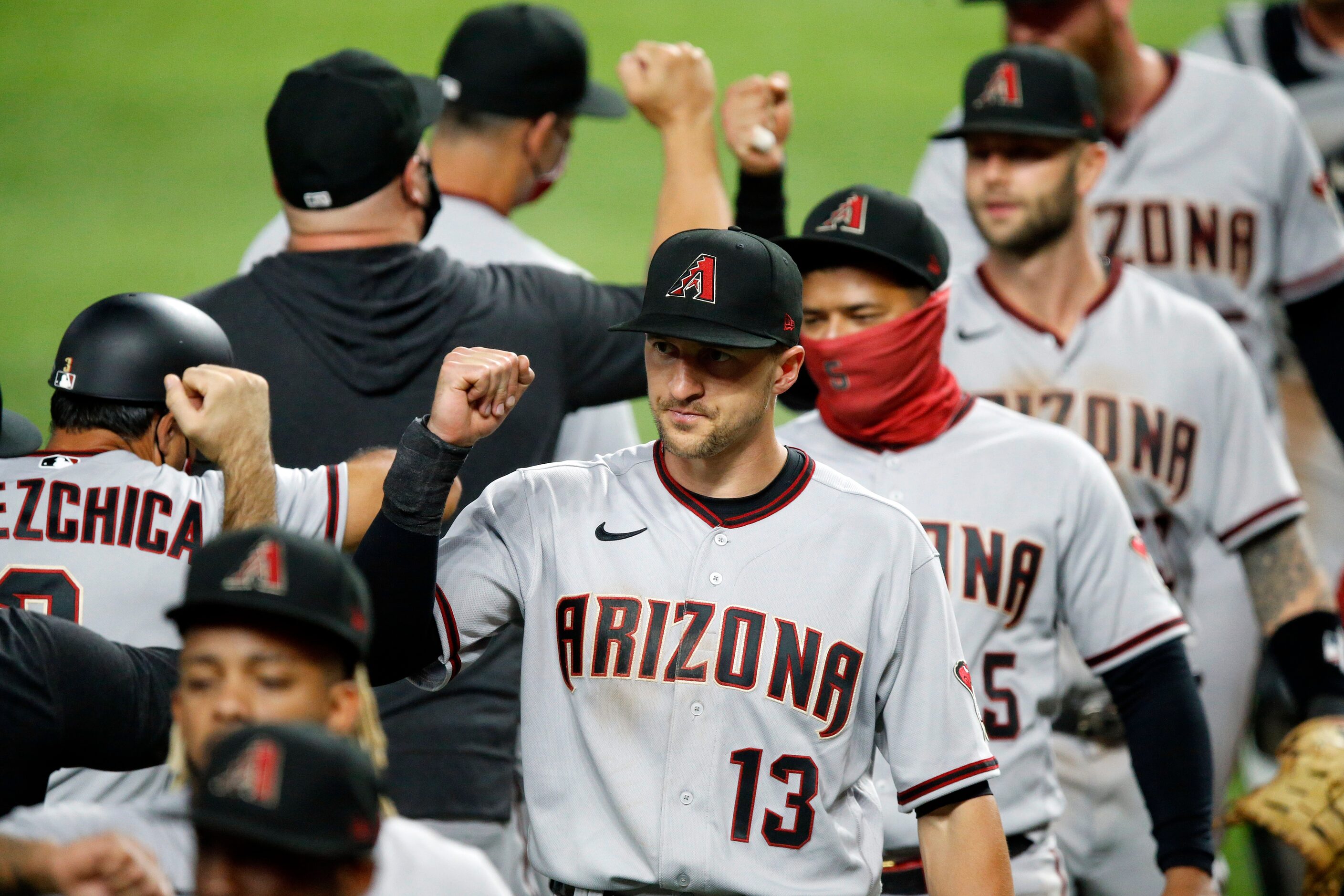 Arizona Diamondbacks shortstop Nick Ahmed (13) elbow bumps his teammates after defeating the...