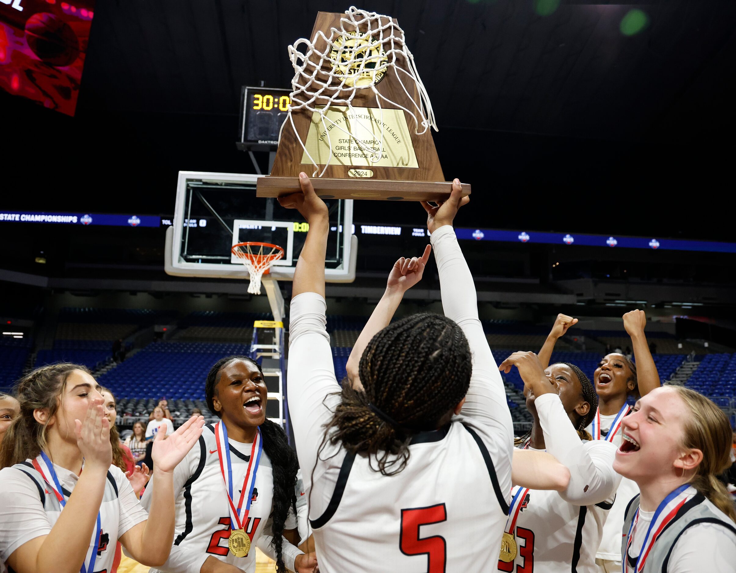 Frisco Liberty's Keyera Roseby (5) lifts the trophy after winning the UIL Class 5A state...