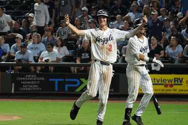 Argyle's Alex D’Angelo (2) celebrates scoring a run as Colton Roquemore heads to the...