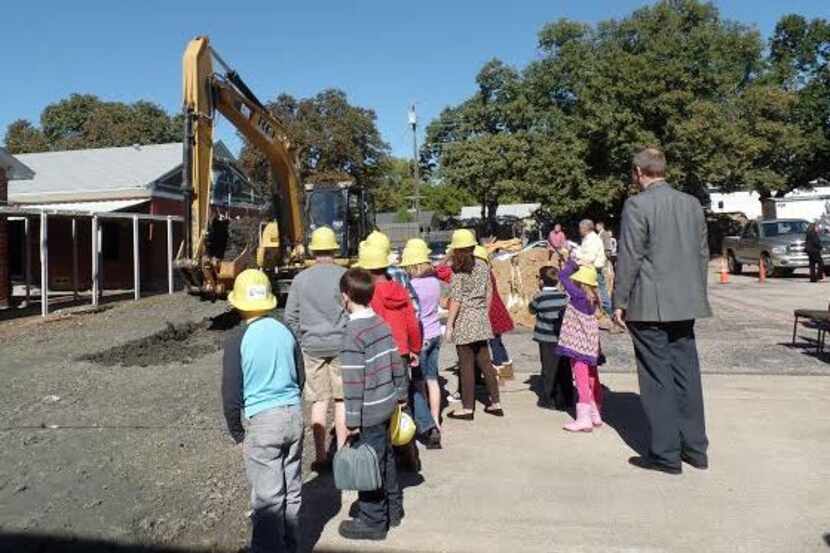  Pastor Jim Gerlach and several children from Oak View Baptist watch the groundbreaking.