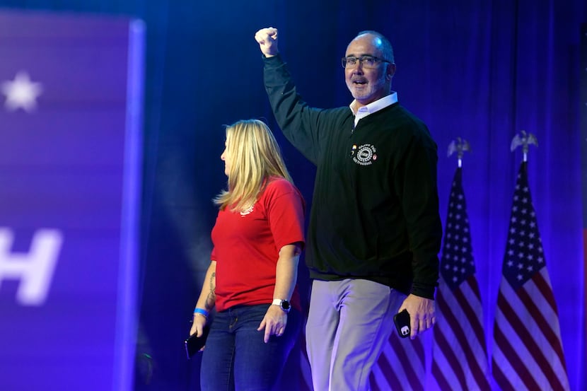 United Auto Workers president Shawn Fain walks onto stage with Dawn Simms, UAW Local 126...