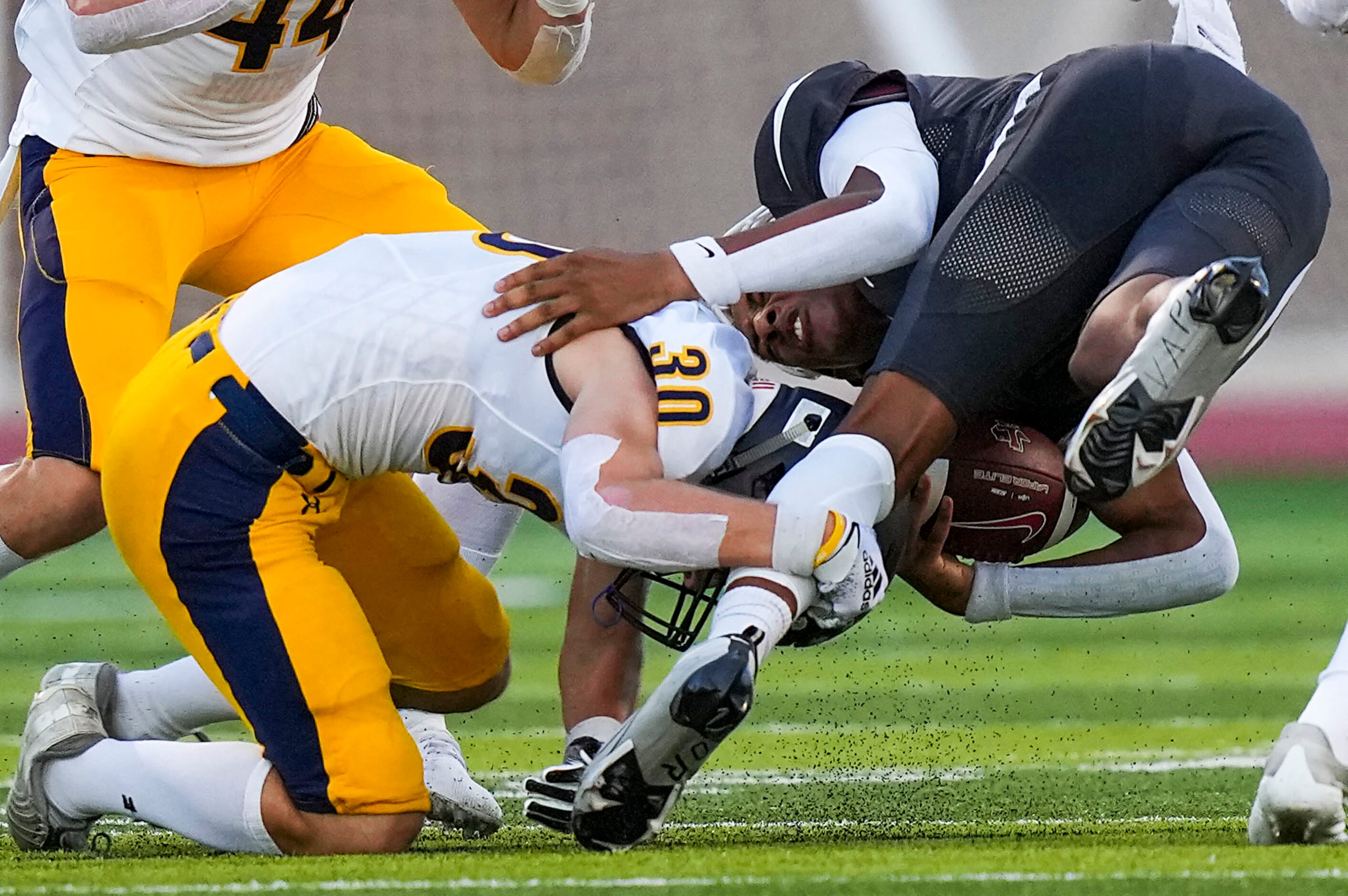 Lewisville quarterback  Ethan Terrell (7) is brought down by Highland Park defensive back...