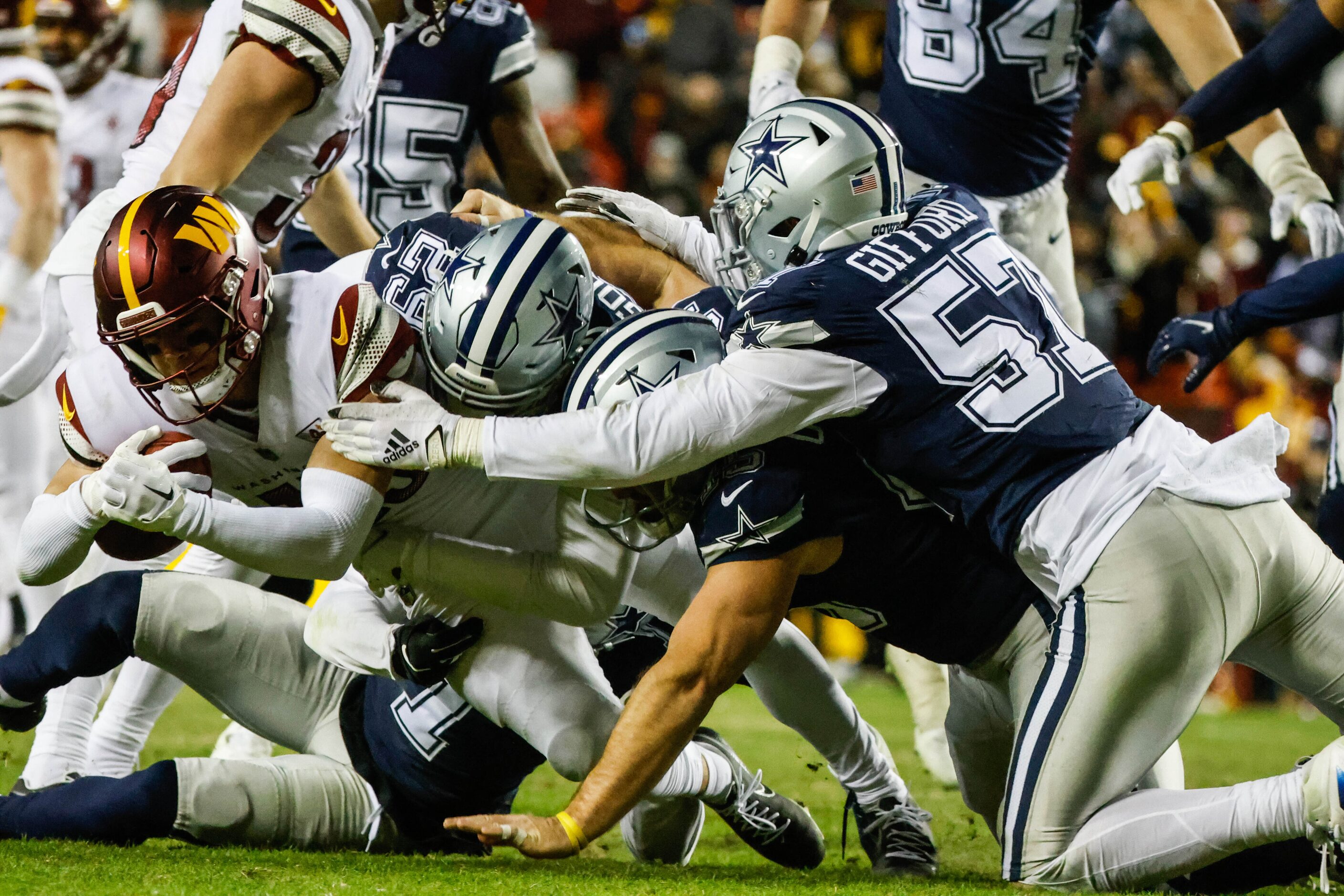 Washington Commanders wide receiver Dax Milne (15) gets tackled by Dallas Cowboys cornerback...