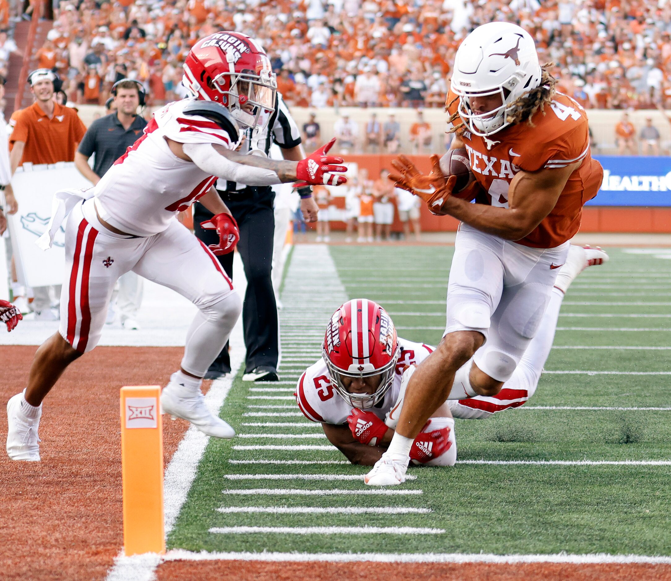 Texas Longhorns wide receiver Jordan Whittington (4) breaks a tackle by Louisiana-Lafayette...