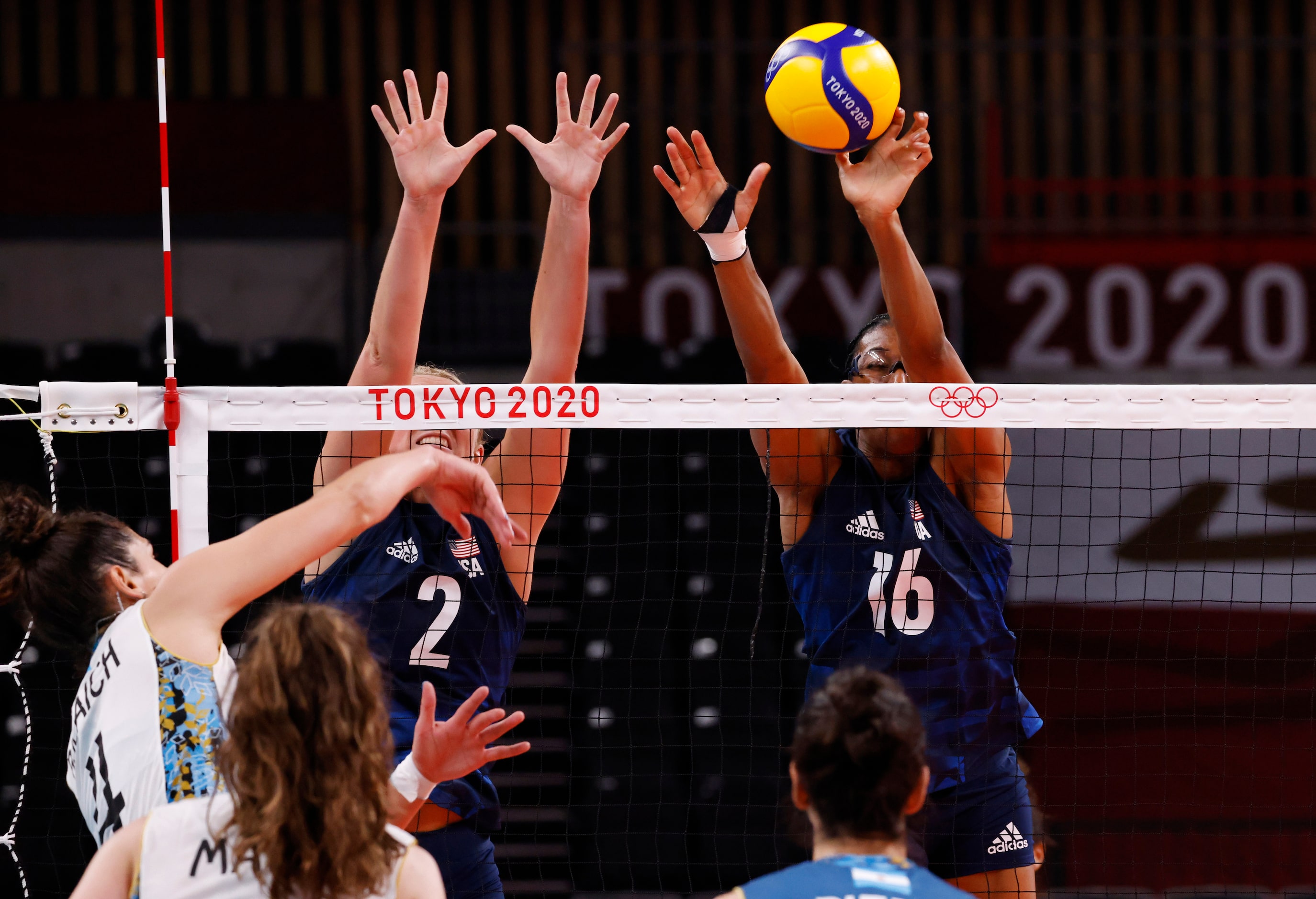 USA’s Jordyn Poulter (2) and Foluke Akinradewo (16) block a ball hit by Argentina’s Julieta...