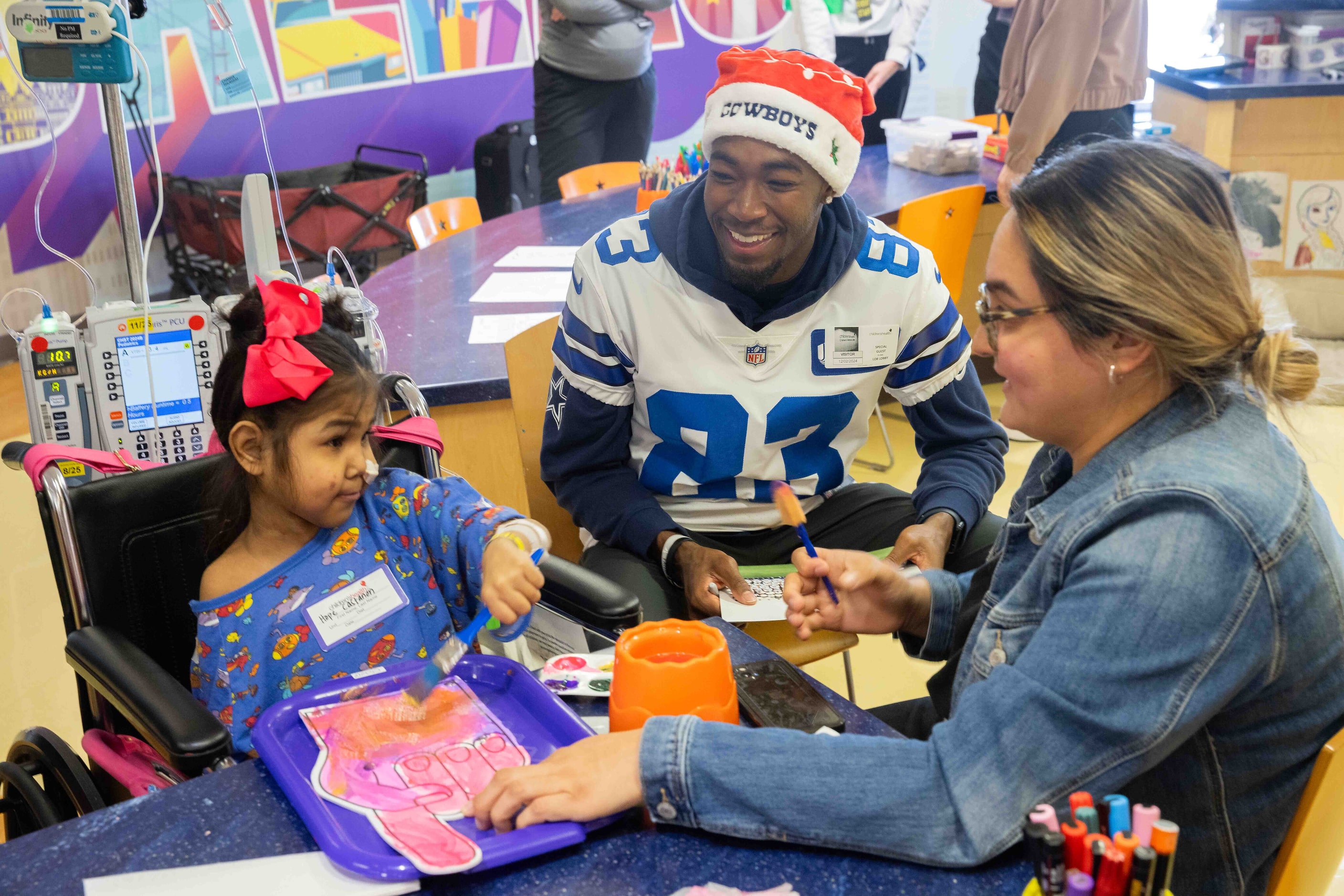 Dallas Cowboys wide receiver Jalen Brooks (83) shares a smile with Hope Castanon, 7, and her...