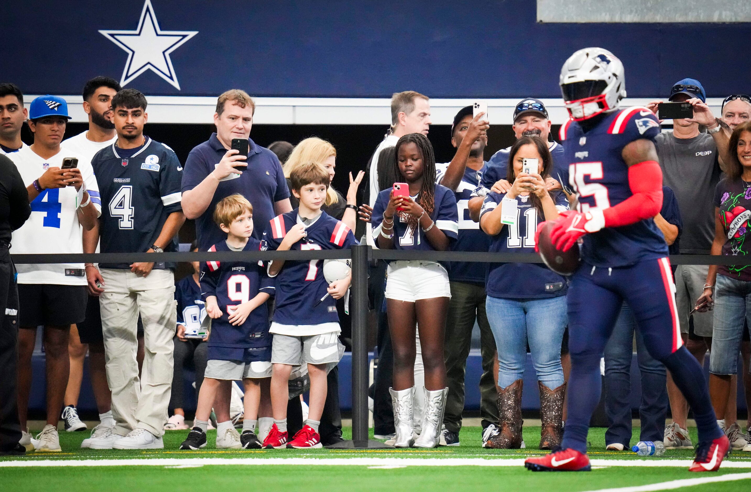 Dallas Cowboys fans watch as New England Patriots running back Ezekiel Elliott (15) warms up...