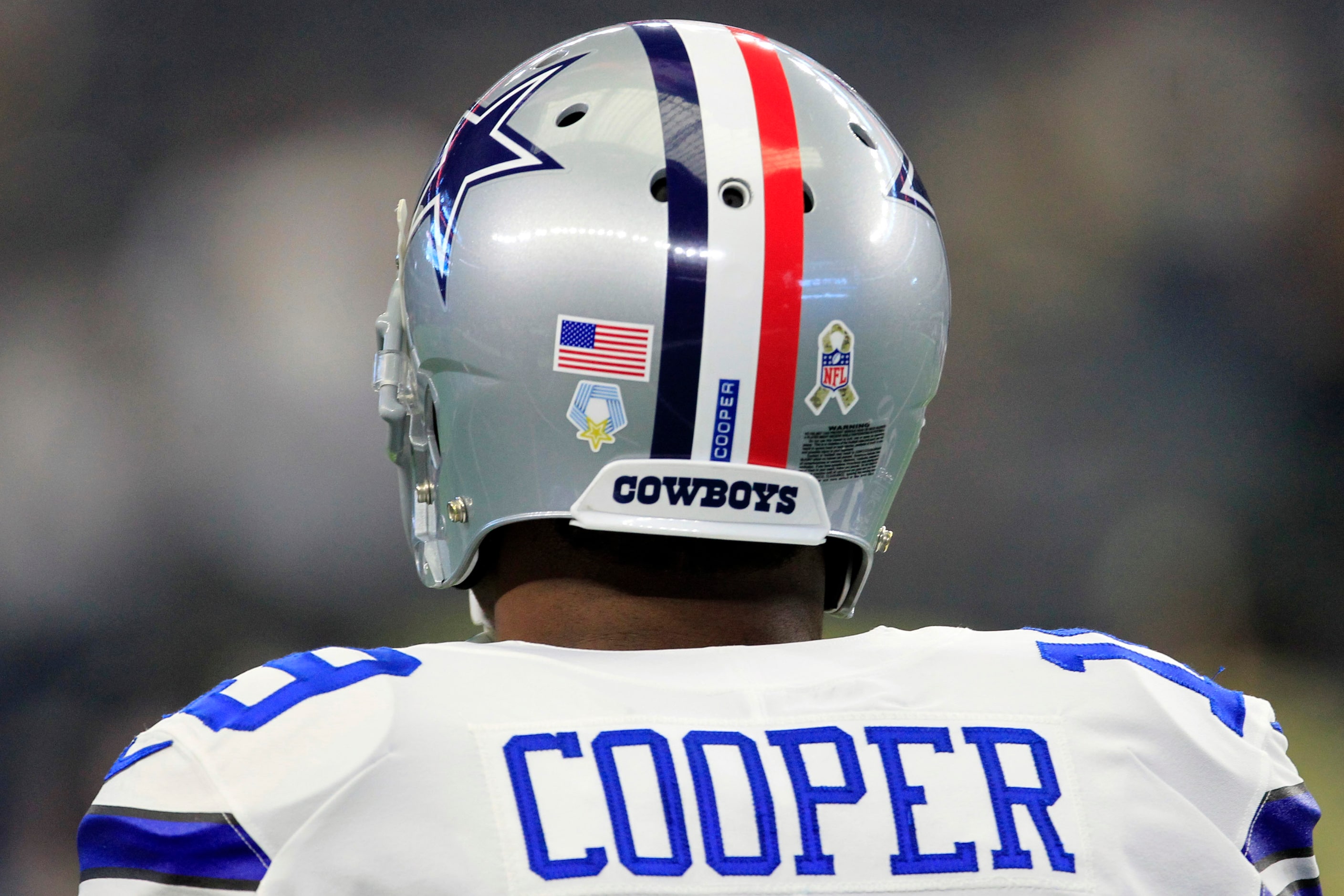 Dallas Cowboys wide receiver Amari Cooper (19) sports a helmet with red, white and blue...