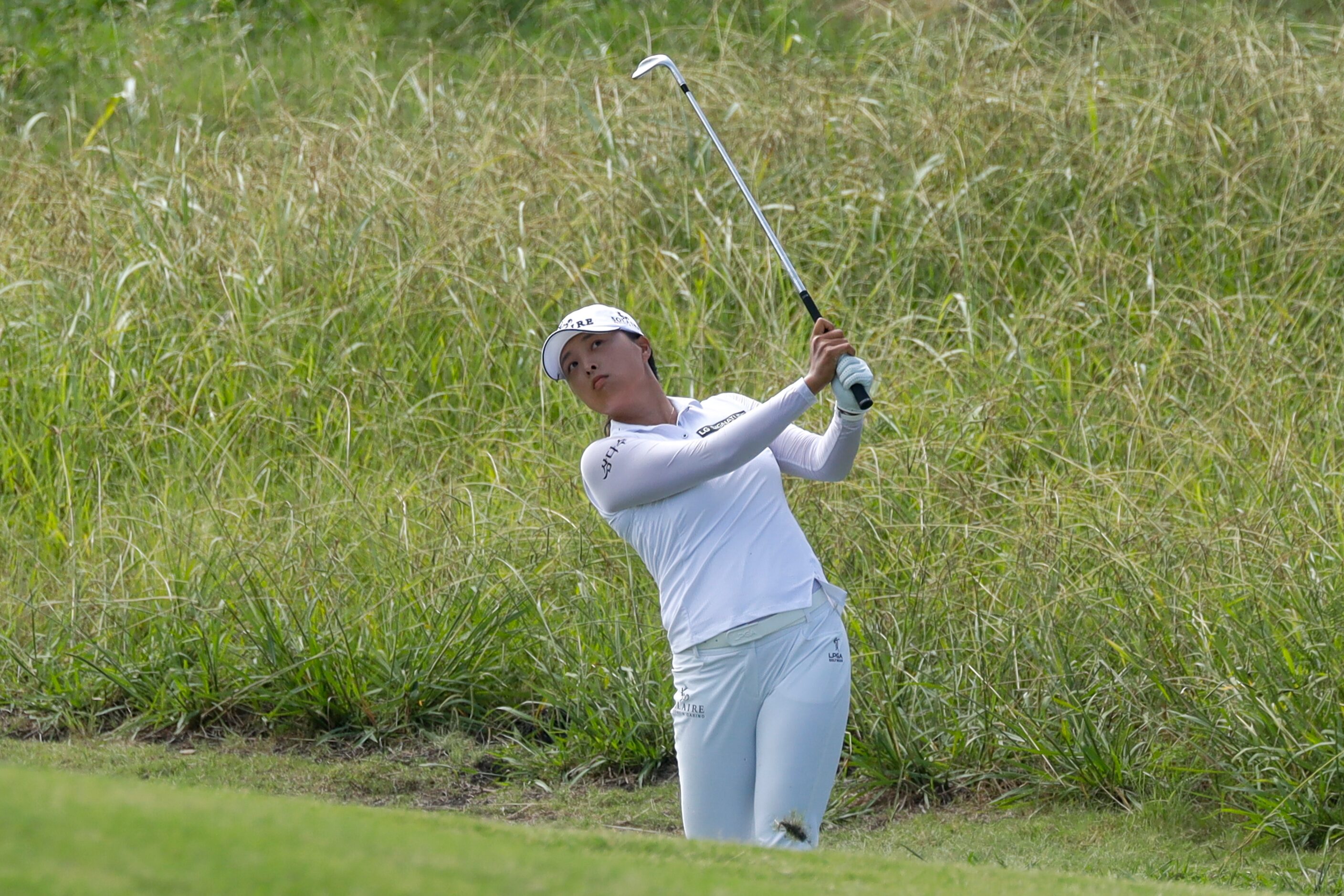 Professional golfer Jin Young Ko chips a shot onto the No. 2 green during the third round of...