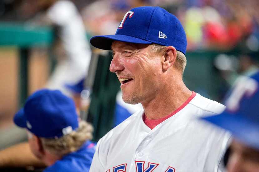 Texas Rangers' manager Jeff Banister laughs in the dugout during a baseball game against the...