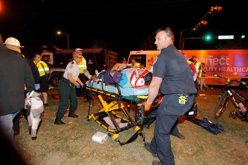 New Orleans emergency personnel attended to an injured parade watcher after a pickup truck...