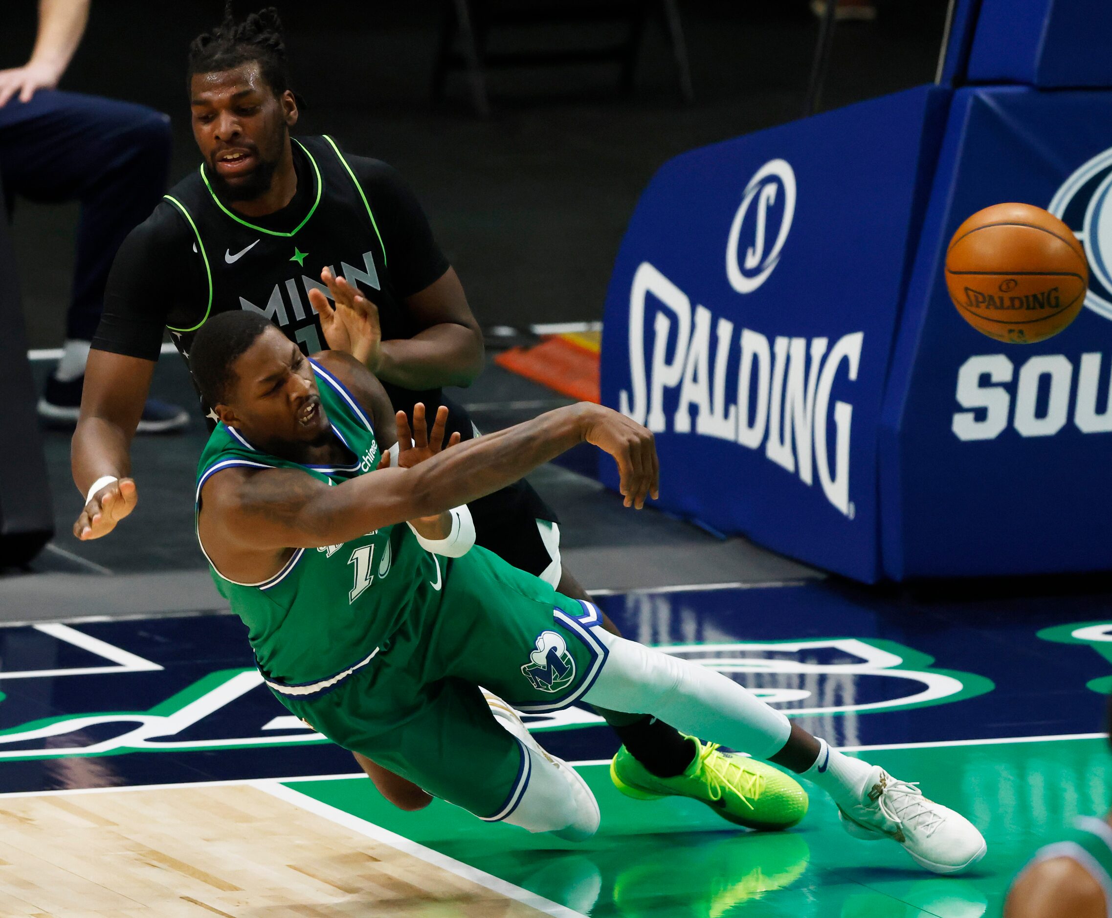 Dallas Mavericks forward Dorian Finney-Smith (10) is fouled by Minnesota Timberwolves center...