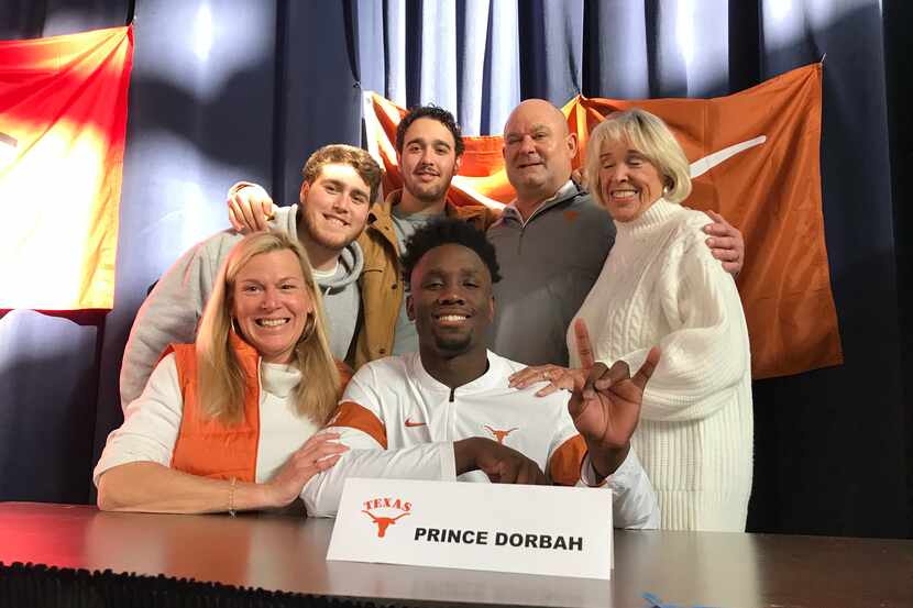 Highland Park defensive end Prince Dorbah poses with his family during the school's early...