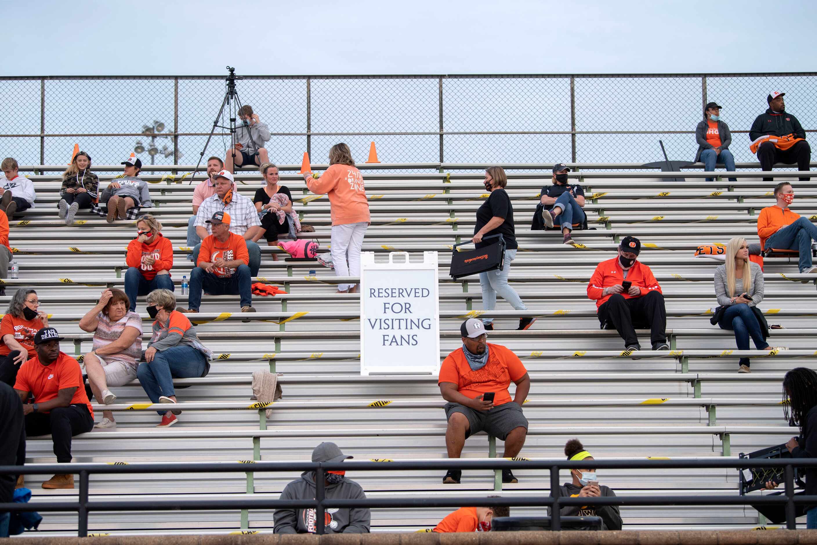 Rockwall fans practice social distancing before a high school football game against Jesuit...