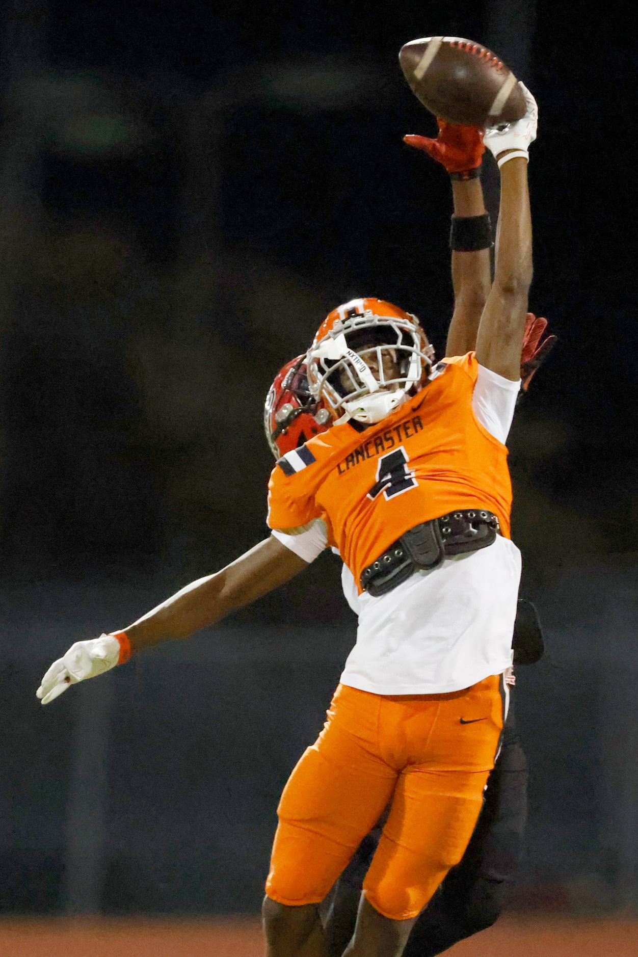 Lancaster defensive back Victor Lincoln (4) breaks up a pass intended for Cedar Hill wide...