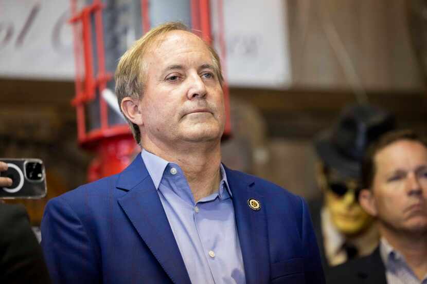 Attorney General Ken Paxton listens as wife Sen. Angela Paxton thanks the crowd in Plano...