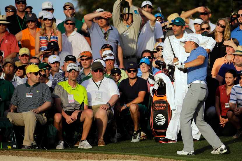 Jordan Spieth watches his shot out of the gallery on the 18th hole during the third round of...