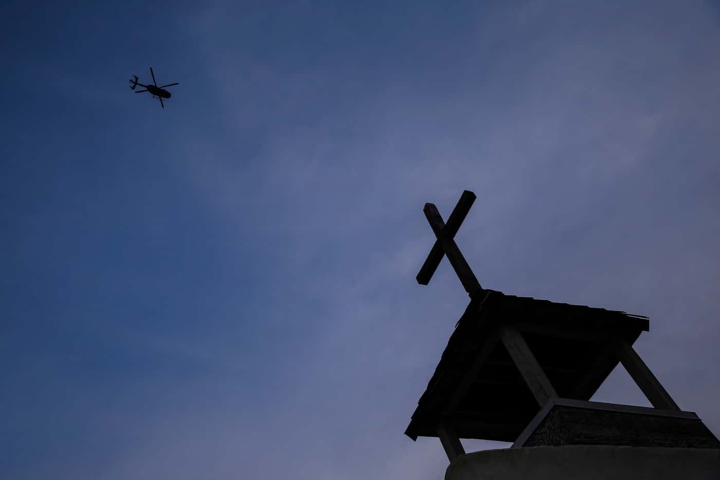 A Department of Homeland Security helicopter passes over the historic La Lomita chapel while...