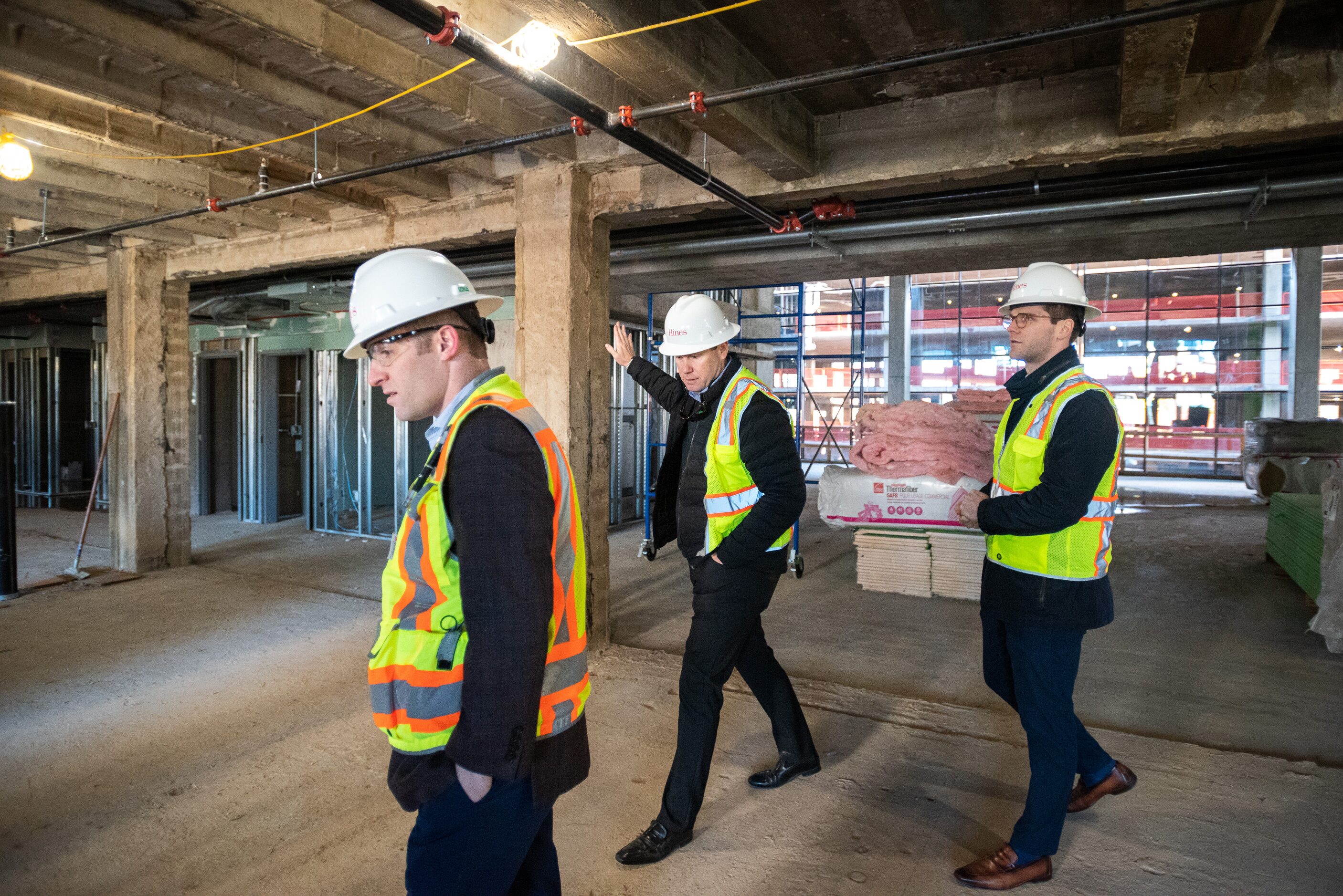 David Freisner, construction manager, left, Ben Brewer, Hines Senior Managing Director, and...