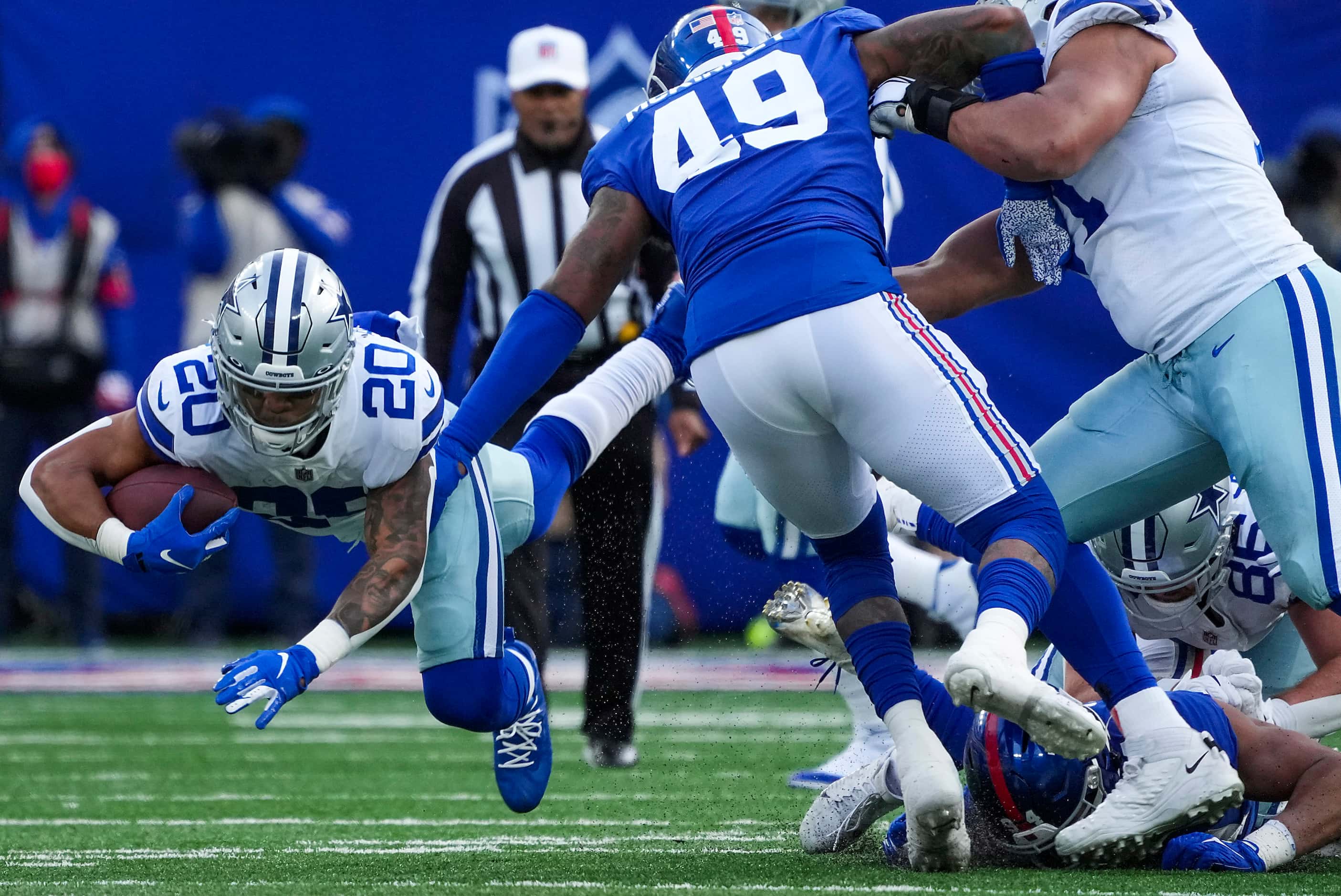 Dallas Cowboys running back Tony Pollard (20) dives for a first down pst New York Giants...