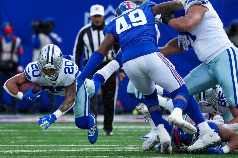 Dallas Cowboys running back Tony Pollard (20) dives for a first down pst New York Giants...