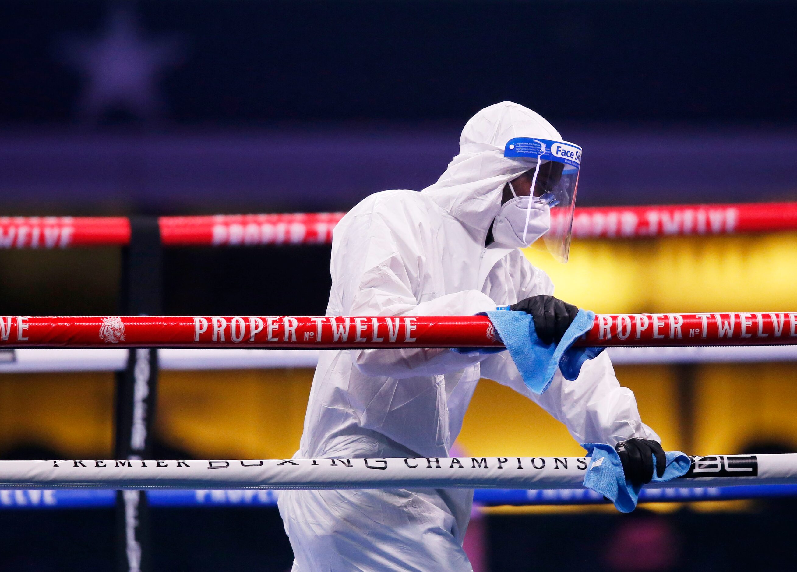 A cleaning crew in protective gear cleans the rings after a fight between Burley Brooks and...