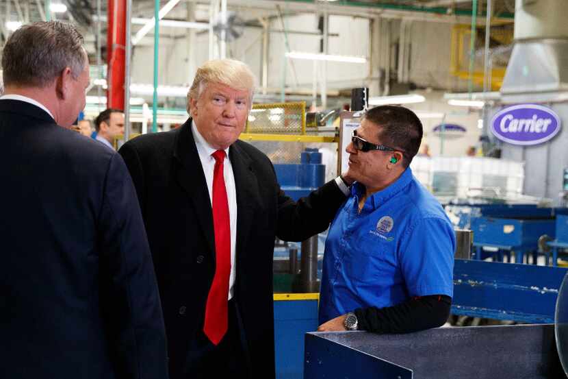 President-elect Donald Trump talks with workers during a visit to the Carrier factory,...