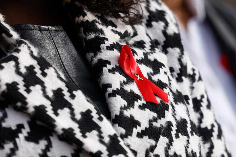 Vice-president and COO Yolanda Jones wears a red ribbon for World AIDS Day during a ribbon...