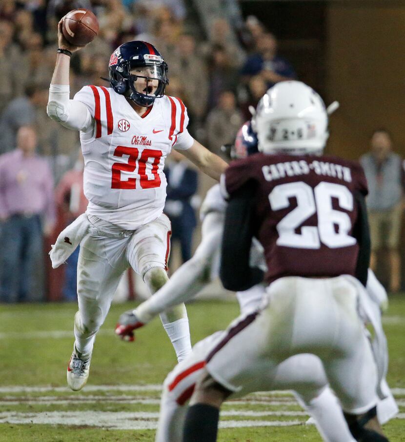 Mississippi Rebels quarterback Shea Patterson (20) fakes a pass as he scrambles for critical...