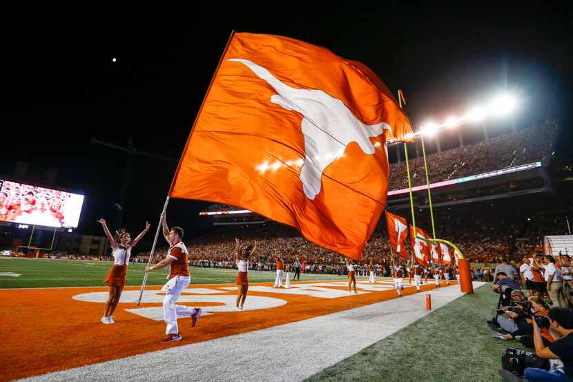 Longhorns cheerleaders bolt through the end zone after a Texas touchdown during the fourth...