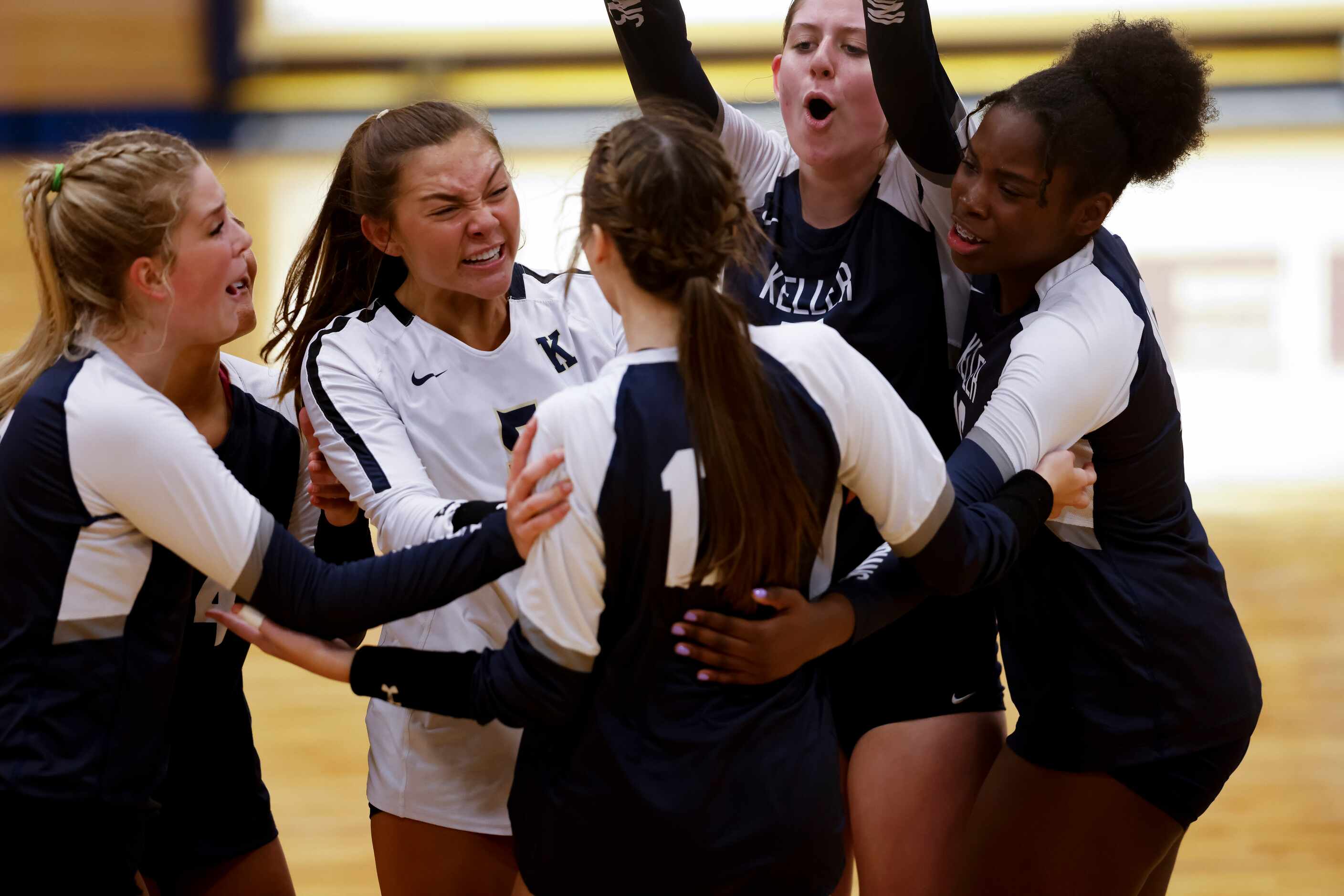 Keller players celebrate leading against Southlake Carroll during the third set of a 4-6A...