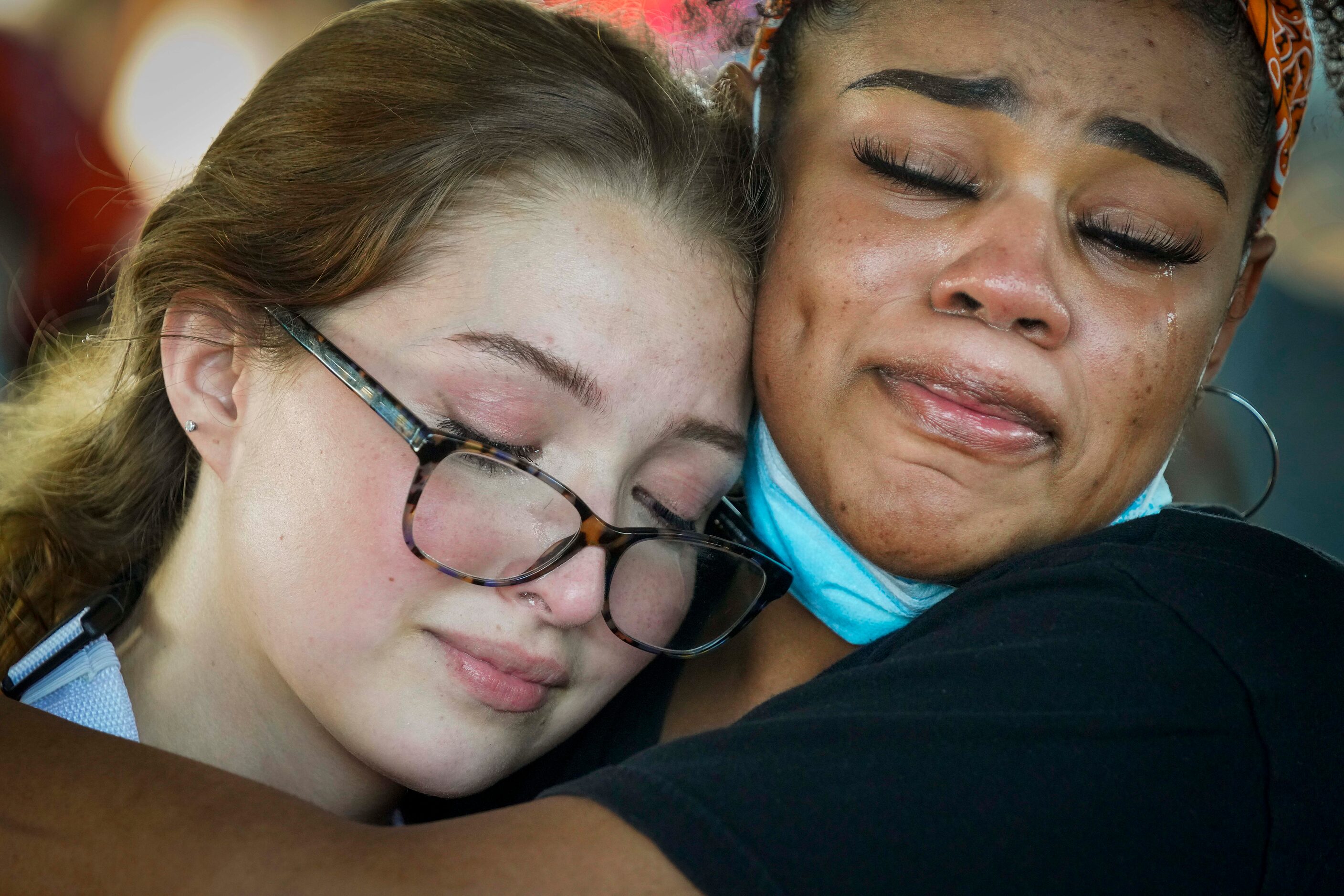 Tears stream down their cheeks as organizers Bela Marcano (left) and Monique Mitchell as...