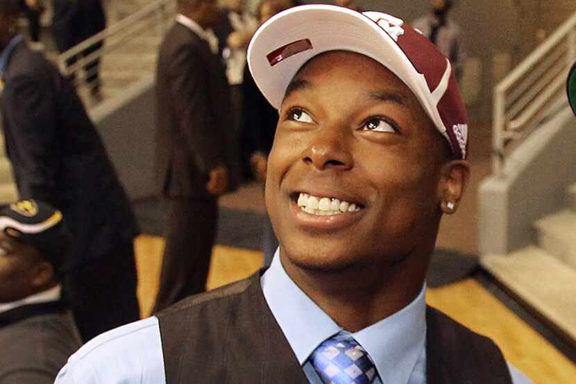Thomas Johnson smiles after formally committing to Texas A&M at Dallas ISD's National...