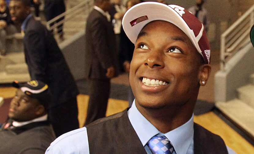 Thomas Johnson smiles after formally committing to Texas A&M at Dallas ISD's National...