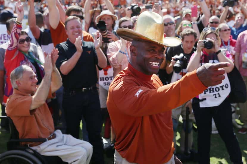 Texas Longhorns head coach Charlie Strong celebrates with the Golden Hat after his team...