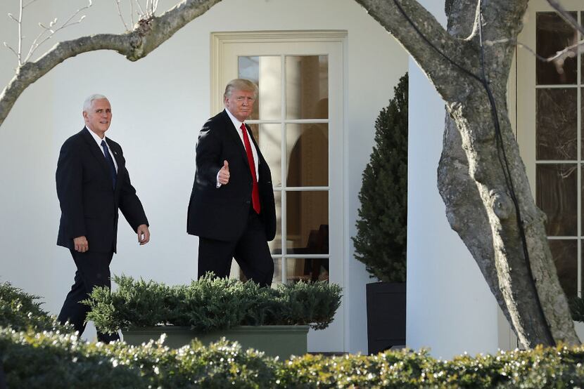 U.S. President Donald Trump, right, gestures while arriving at the White House with U.S....