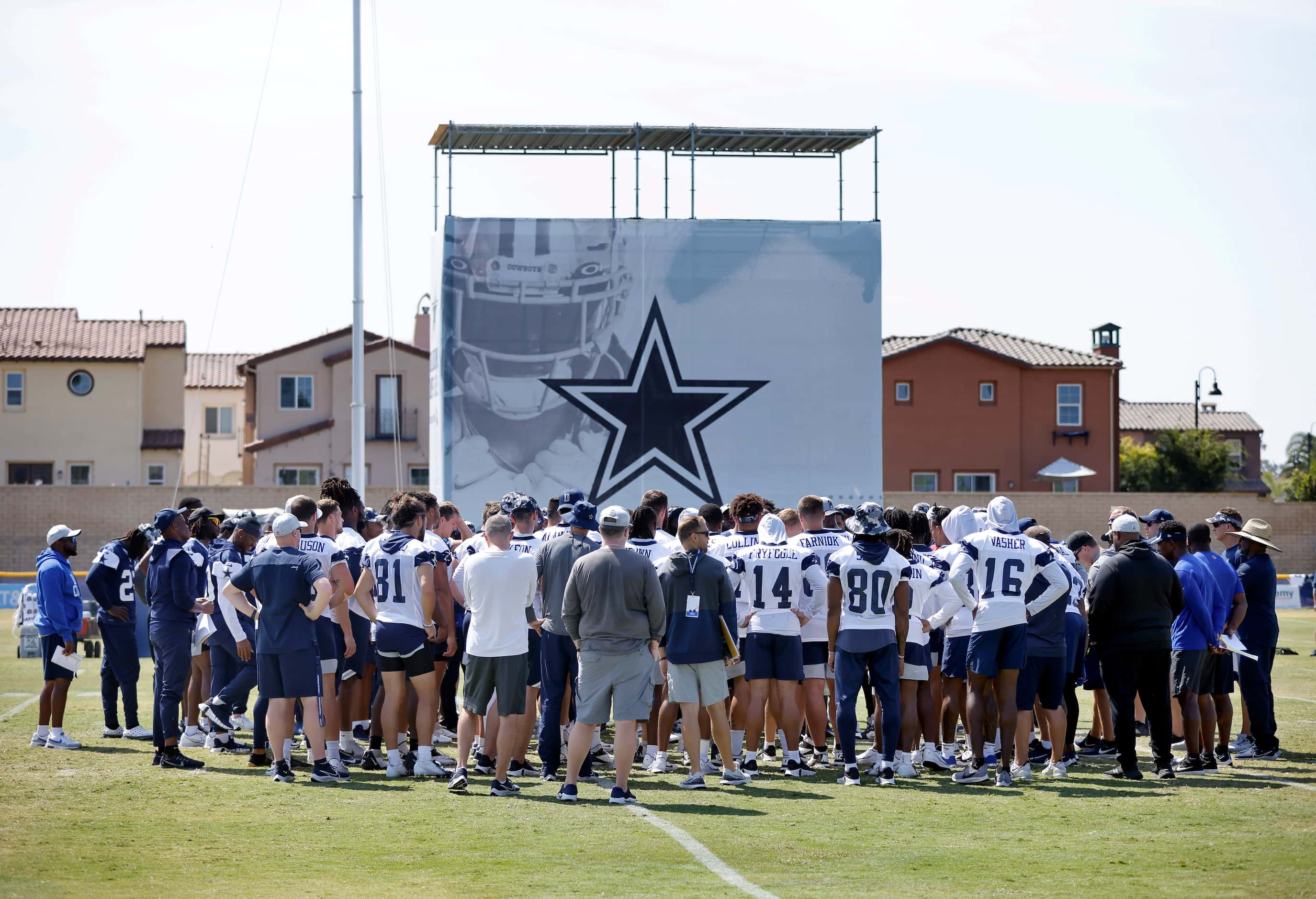 The Dallas Cowboys football players gather t midfield following a mock game at training camp...
