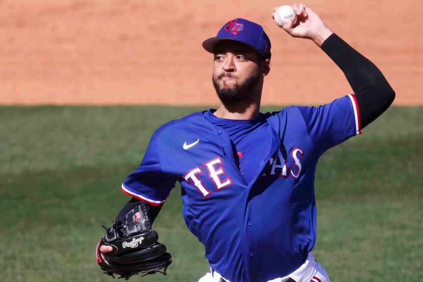 Texas Rangers’ Antoine Kelly throws a pitch during the third inning of a spring training...