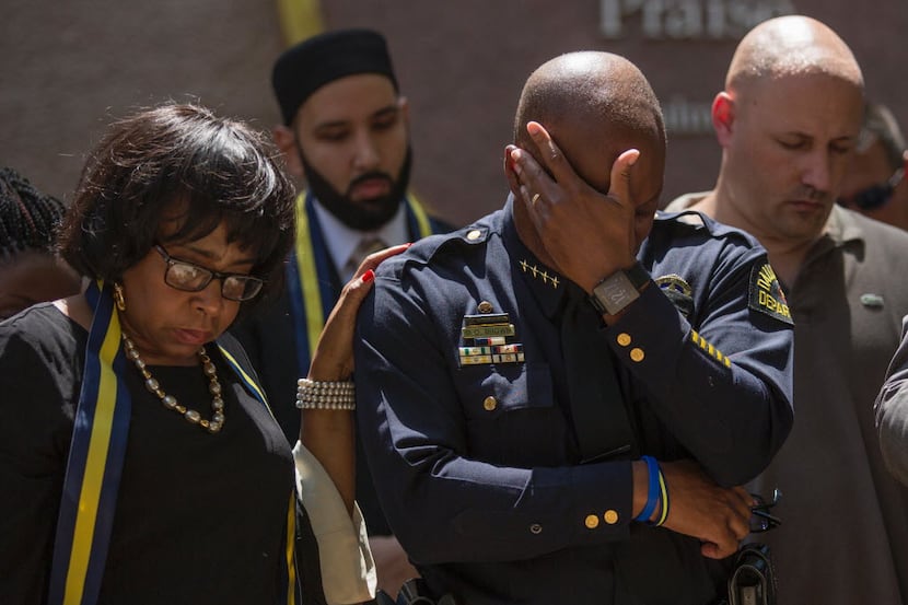 Dallas Police Chief David Brown prayed during a a vigil at Thanks-Giving Square on Friday...