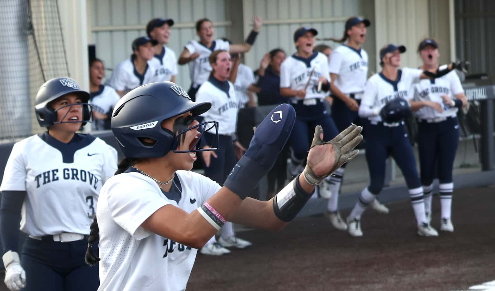 Prosper Walnut Creek shortstop Camila Spriggs (9), lower left, lets out a yell after scoring...