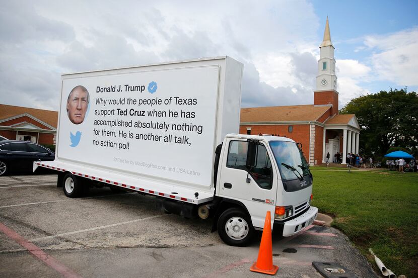 An ad billboard truck with a tweet from President Donald Trump featuring Ted Cruz parked...