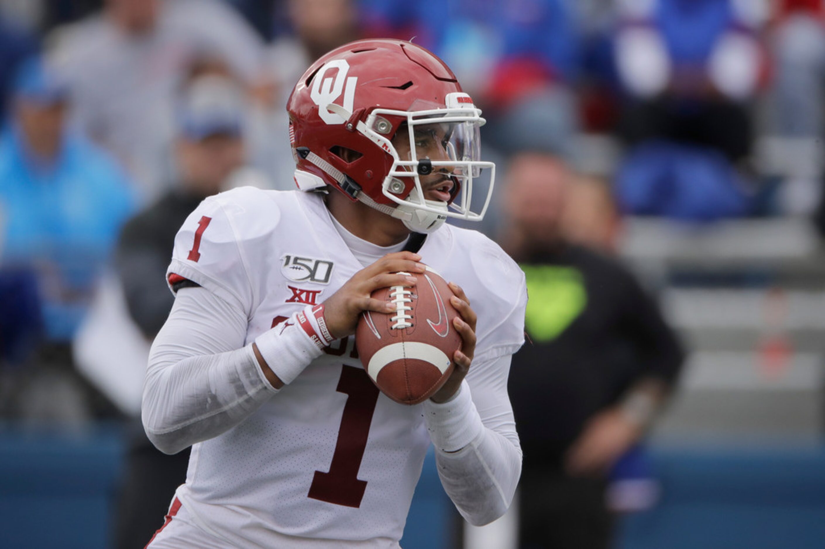 Oklahoma quarterback Jalen Hurts looks for a receiver during the second half of an NCAA...