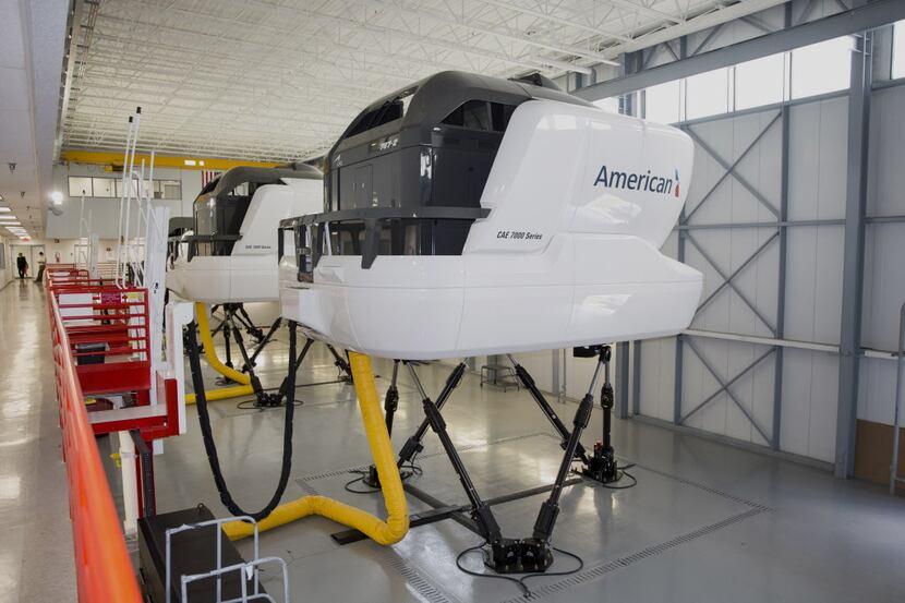 Flight simulators stand at the American Airlines Inc. Flight Training Center in Fort Worth,...