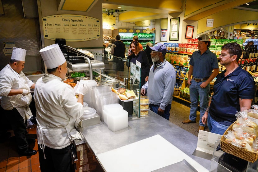 Customers order and wait for their lunch from the grill section at the original Eatzi’s on...