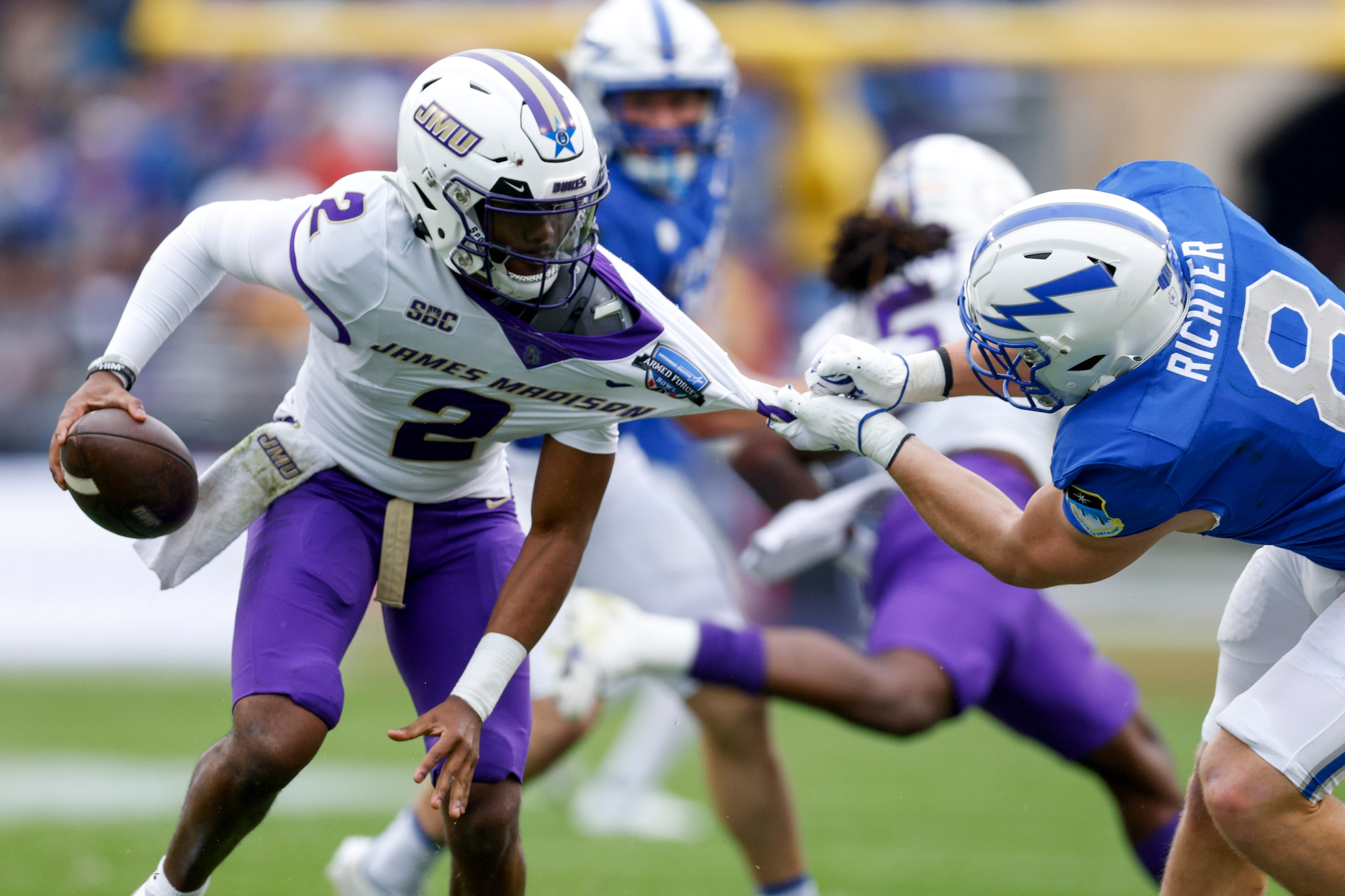 Air Force Falcons linebacker Bo Richter (8) grabs the jersey of James Madison Dukes...