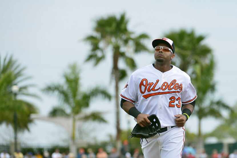 Baltimore Orioles outfielder Nelson Cruz  (23) runs off the field after the third inning...
